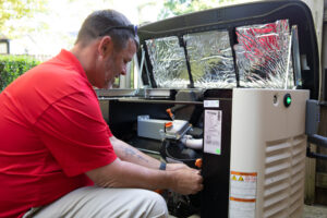 A man servicing an open generator